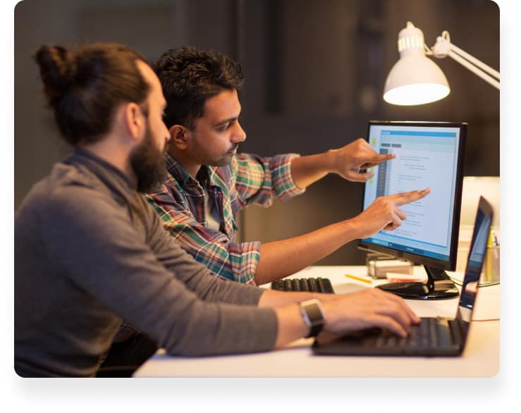 Web developers working together on code