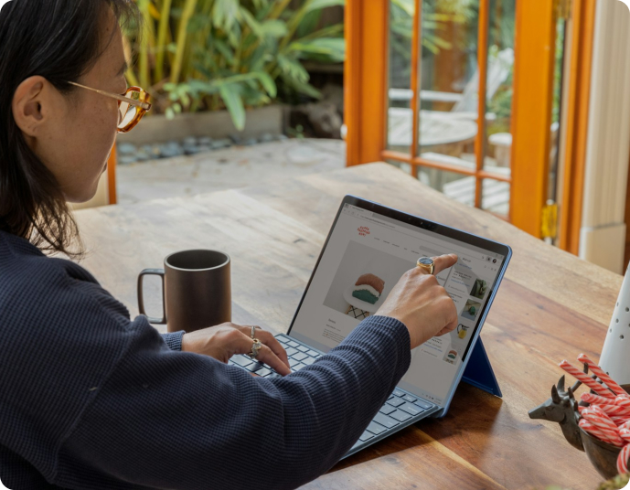 Person working on laptop at wooden table